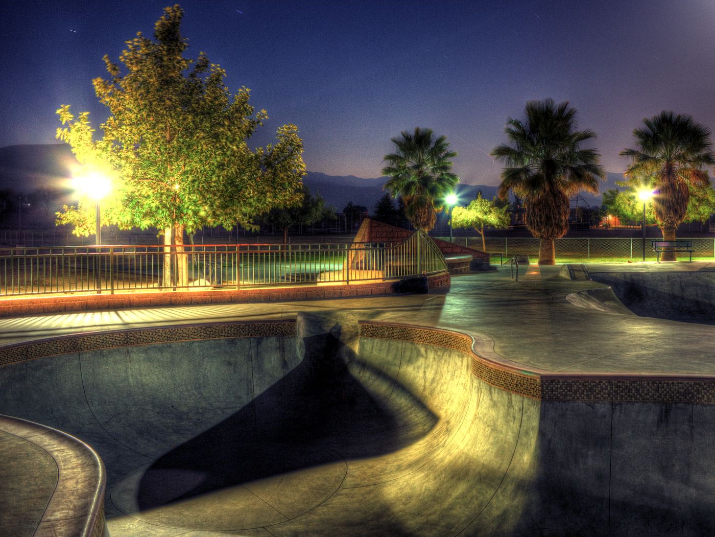 A well-lit skatepark at night, representing structure and design